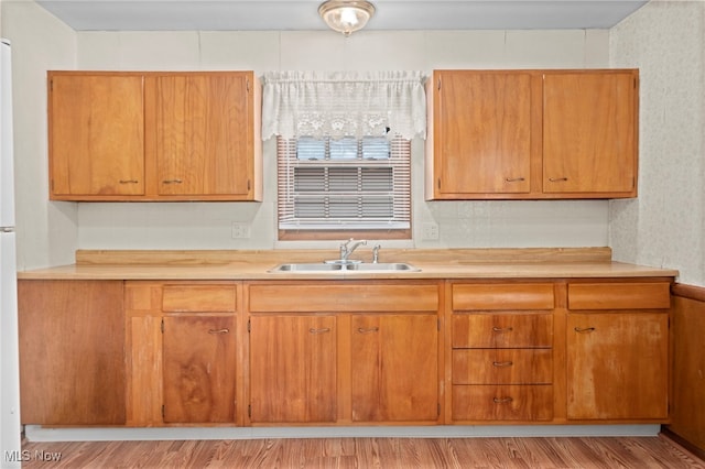 2100 Priscilla Ave NW, Massillon, OH 44647 - kitchen with light countertops, light wood finished floors, and brown cabinetry