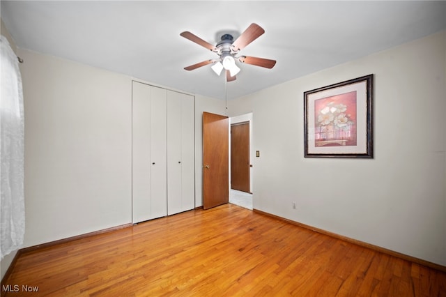 2100 Priscilla Ave NW, Massillon, OH 44647 - unfurnished bedroom featuring light wood-style flooring, a closet, and a ceiling fan