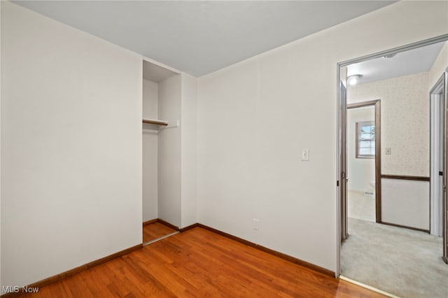 2100 Priscilla Ave NW, Massillon, OH 44647 - unfurnished bedroom featuring a closet and wood finished floors