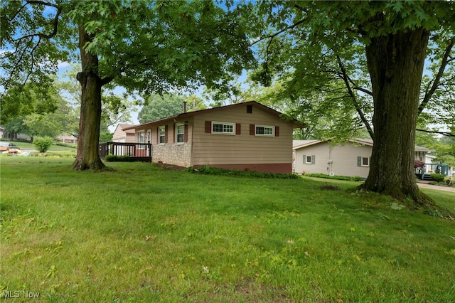 2100 Priscilla Ave NW, Massillon, OH 44647 - view of side of property with a yard and a deck