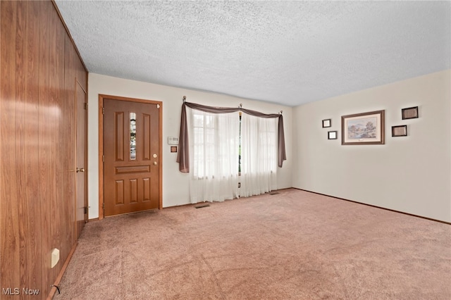 2100 Priscilla Ave NW, Massillon, OH 44647 - carpeted entrance foyer with a textured ceiling and wood walls