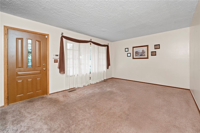 2100 Priscilla Ave NW, Massillon, OH 44647 - foyer featuring carpet flooring and a textured ceiling