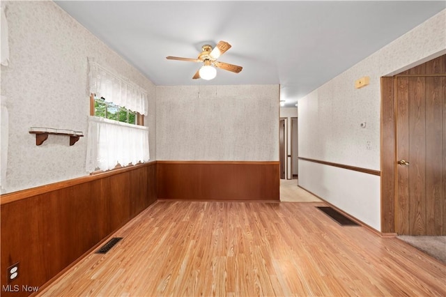 2100 Priscilla Ave NW, Massillon, OH 44647 - spare room with wood finished floors, a ceiling fan, and wallpapered walls