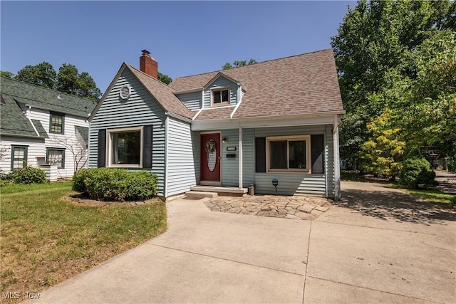 260 Morgan, Oberlin, OH 44074 - view of front facade featuring a chimney, a shingled roof, and a front yard