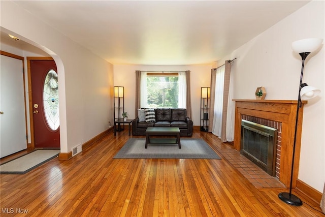 260 Morgan, Oberlin, OH 44074 - living area with hardwood / wood-style flooring, arched walkways, and a brick fireplace
