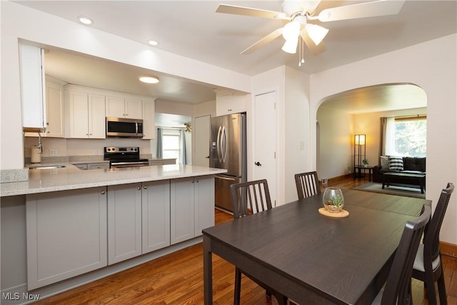 260 Morgan, Oberlin, OH 44074 - dining area featuring arched walkways, wood finished floors, ceiling fan, and recessed lighting