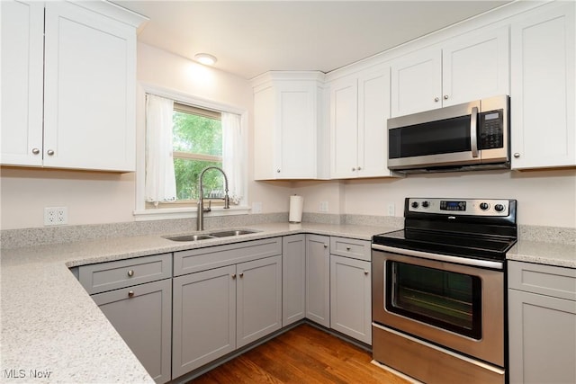 260 Morgan, Oberlin, OH 44074 - kitchen featuring stainless steel appliances, light countertops, dark wood finished floors, white cabinets, and gray cabinetry