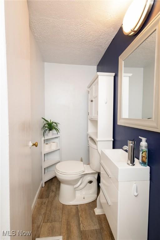 260 Morgan, Oberlin, OH 44074 - half bath with wood finished floors, vanity, and a textured ceiling