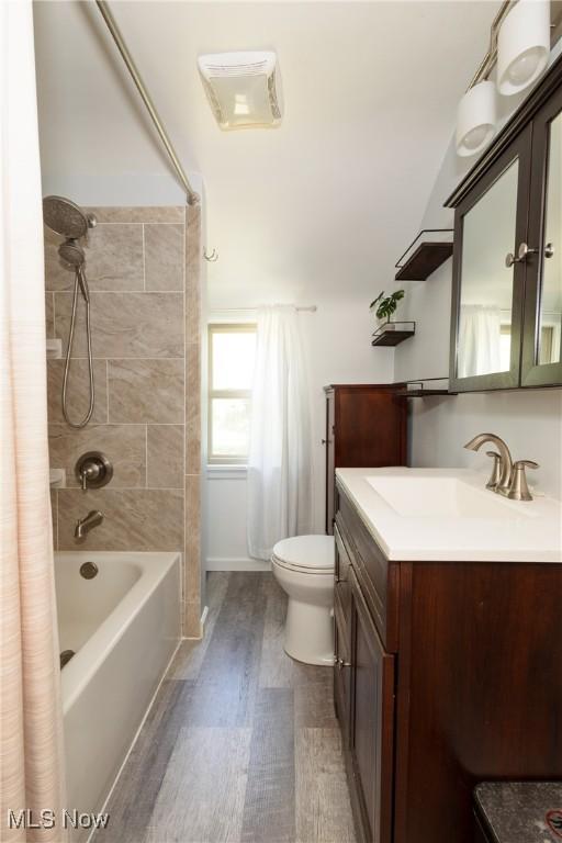 260 Morgan, Oberlin, OH 44074 - full bath with vanity, wood finished floors, and shower / bath combination with curtain