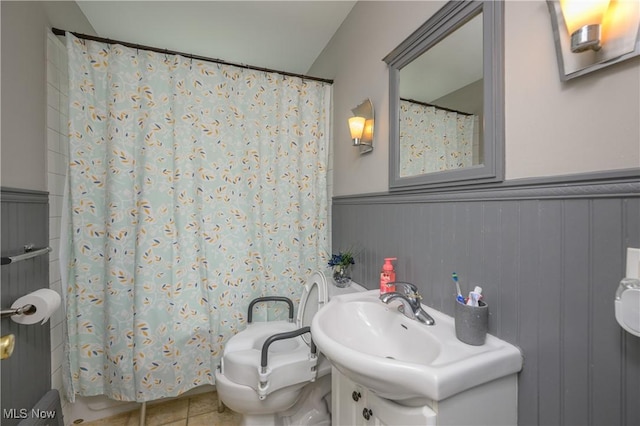 1209 Oak Ave SE, Massillon, OH 44646 - bathroom with wainscoting, tile patterned flooring, vanity, and a shower with curtain