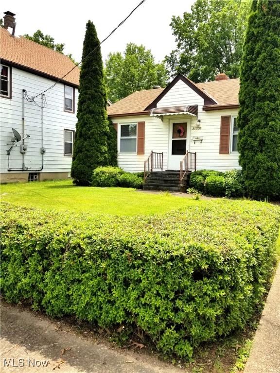 21050 N Vine Ave, Euclid, OH 44119 - bungalow-style house featuring a chimney and a front yard
