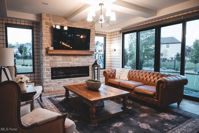 7363 Kempton Ct, Canfield, OH 44406 - living room with wood finished floors, beamed ceiling, plenty of natural light, a chandelier, and a stone fireplace