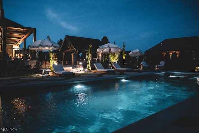7363 Kempton Ct, Canfield, OH 44406 - pool at night with an outdoor pool and a patio
