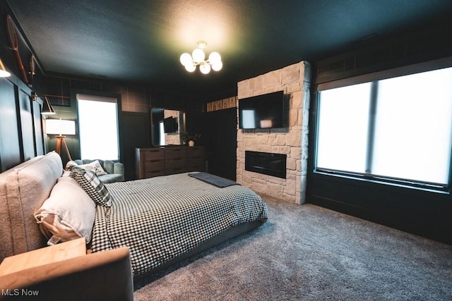 7363 Kempton Ct, Canfield, OH 44406 - bedroom with multiple windows, a chandelier, carpet floors, and a fireplace