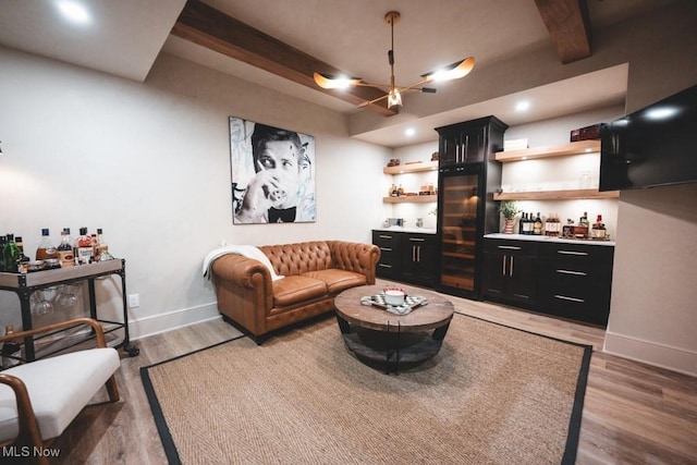 7363 Kempton Ct, Canfield, OH 44406 - living area with light wood-style flooring, beamed ceiling, and a bar