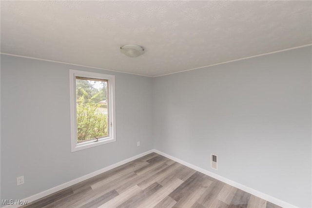 6114 Crossview Rd, Seven Hills, OH 44131 - spare room featuring wood finished floors and baseboards