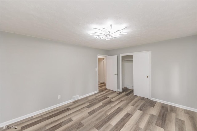 6114 Crossview Rd, Seven Hills, OH 44131 - unfurnished bedroom with light wood-type flooring, a closet, and a textured ceiling