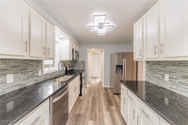 6114 Crossview Rd, Seven Hills, OH 44131 - kitchen with appliances with stainless steel finishes, decorative backsplash, and white cabinets