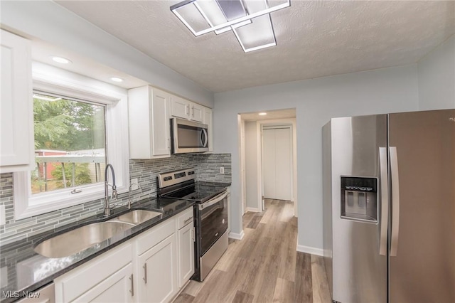 6114 Crossview Rd, Seven Hills, OH 44131 - kitchen featuring stainless steel appliances, backsplash, white cabinets, and a textured ceiling