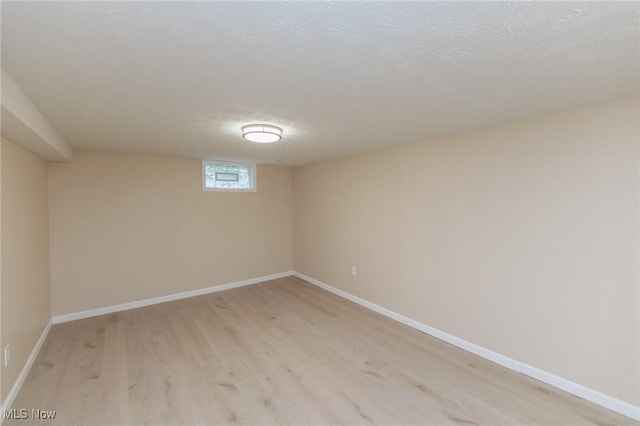 6114 Crossview Rd, Seven Hills, OH 44131 - basement with light wood-style flooring and a textured ceiling
