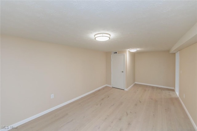 6114 Crossview Rd, Seven Hills, OH 44131 - finished basement with light wood-style flooring and a textured ceiling