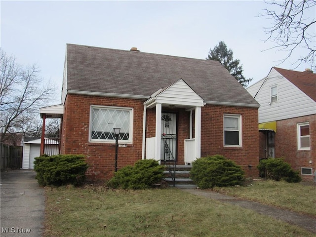 4078 E 154th St, Cleveland, OH 44128 - view of front of house with brick siding, a front lawn, and a shingled roof