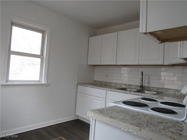 4078 E 154th St, Cleveland, OH 44128 - kitchen featuring white range with electric cooktop, healthy amount of natural light, and decorative backsplash