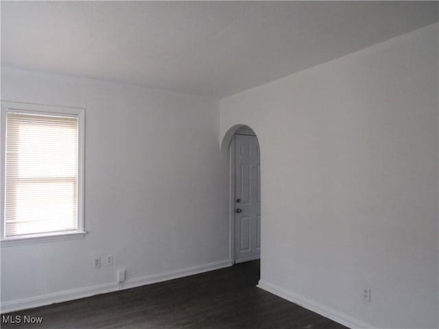 4078 E 154th St, Cleveland, OH 44128 - empty room with dark wood finished floors, arched walkways, and plenty of natural light