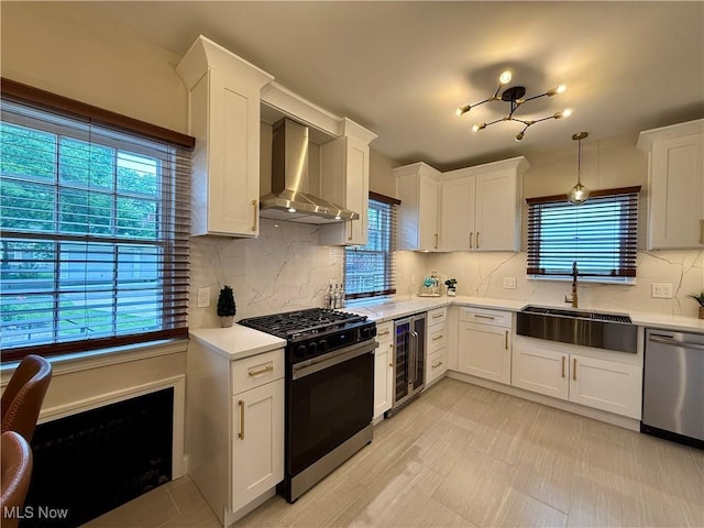 2337 Charney Rd, University Heights, OH 44118 - kitchen with gas stove, wall chimney exhaust hood, dishwasher, and light countertops