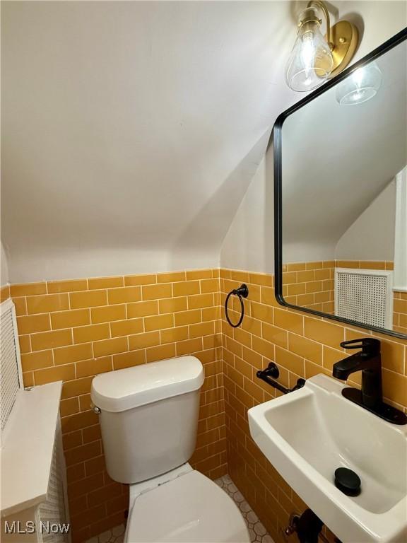 2337 Charney Rd, University Heights, OH 44118 - half bath with tile walls, lofted ceiling, and a wainscoted wall