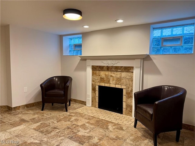 2337 Charney Rd, University Heights, OH 44118 - living area featuring a tiled fireplace, stone finish flooring, and recessed lighting