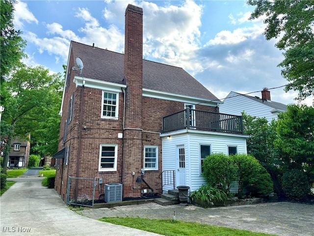 2337 Charney Rd, University Heights, OH 44118 - back of property featuring a balcony, brick siding, and a chimney