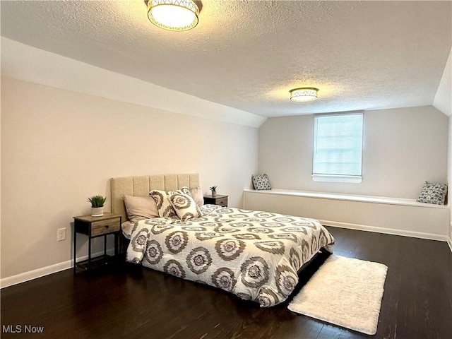 2337 Charney Rd, University Heights, OH 44118 - bedroom featuring wood finished floors, a textured ceiling, and lofted ceiling