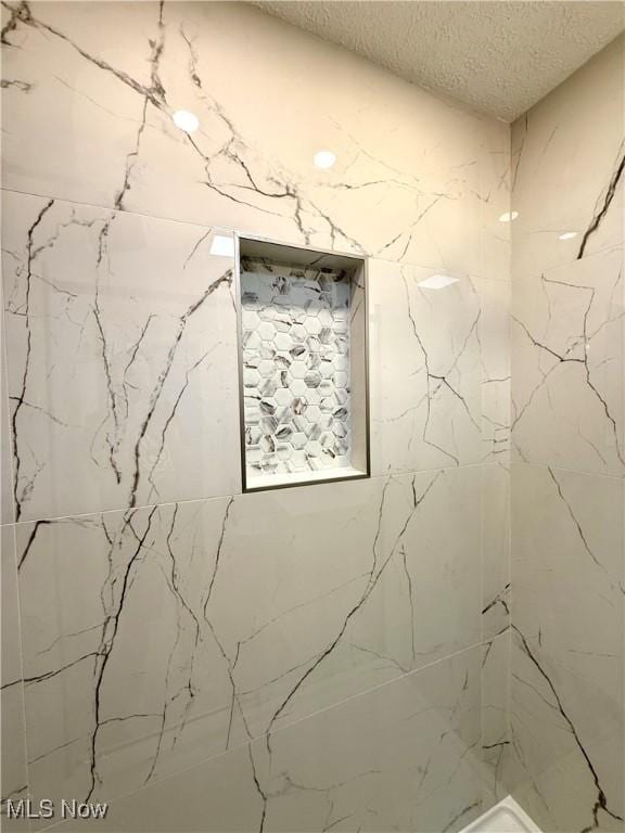 2337 Charney Rd, University Heights, OH 44118 - full bath featuring a textured ceiling and a shower
