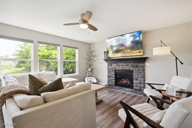 3523 Magnolia Dr, Lorain, OH 44053 - living room with wood finished floors, a stone fireplace, and ceiling fan