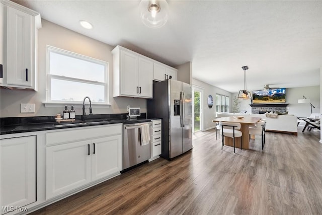 3523 Magnolia Dr, Lorain, OH 44053 - kitchen with stainless steel appliances, dark countertops, white cabinets, healthy amount of natural light, and recessed lighting