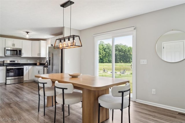 3523 Magnolia Dr, Lorain, OH 44053 - dining area with wood finished floors and baseboards