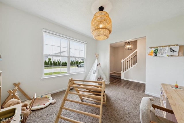 3523 Magnolia Dr, Lorain, OH 44053 - staircase featuring carpet flooring and a chandelier