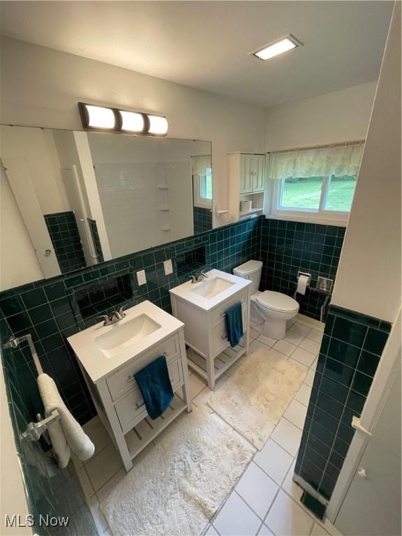 1781 Pleasant Valley Rd, Girard, OH 44420 - bathroom with tile walls, tile patterned floors, vanity, and wainscoting