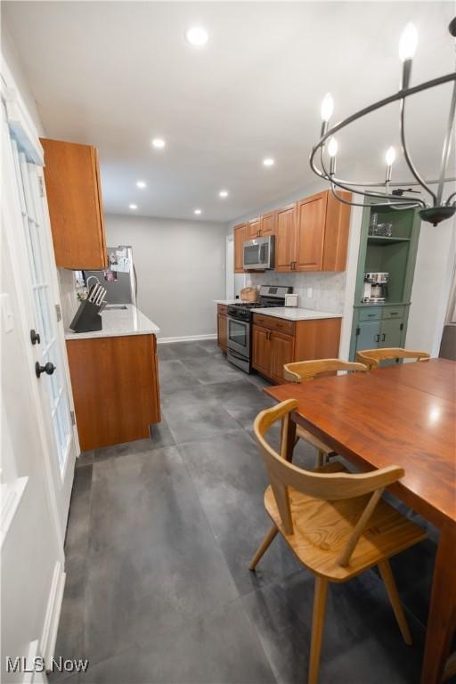 320 Brookfield Ave, Boardman, OH 44512 - kitchen featuring appliances with stainless steel finishes, recessed lighting, brown cabinets, light countertops, and concrete floors