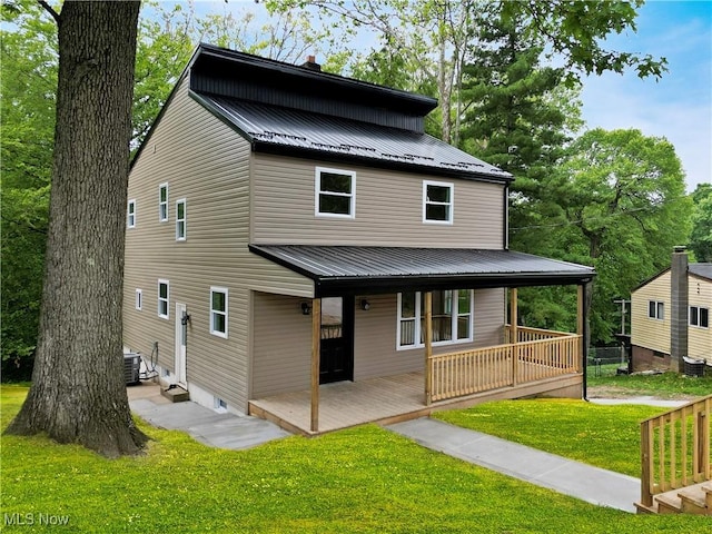 209 Beechwood Blvd, Wintersville, OH 43953 - rear view of property with a metal roof, a yard, and covered porch