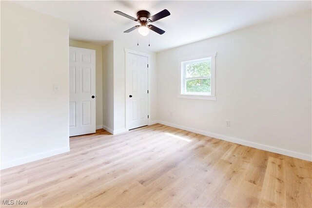 209 Beechwood Blvd, Wintersville, OH 43953 - unfurnished bedroom with light wood-type flooring, ceiling fan, and a closet