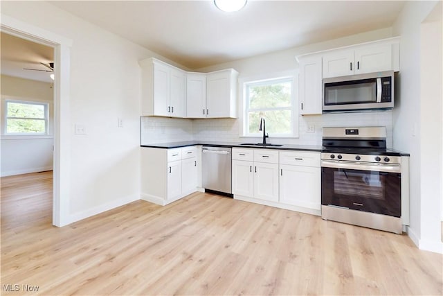 209 Beechwood Blvd, Wintersville, OH 43953 - kitchen featuring stainless steel appliances, light wood-style flooring, decorative backsplash, and healthy amount of natural light