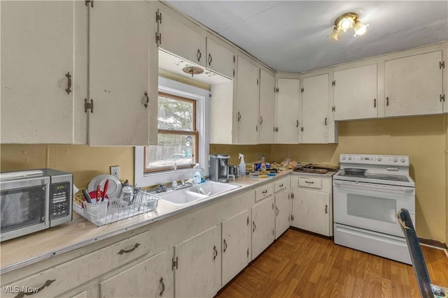 81 S Pleasant St, Oberlin, OH 44074 - kitchen featuring white range with electric stovetop, stainless steel microwave, and light countertops
