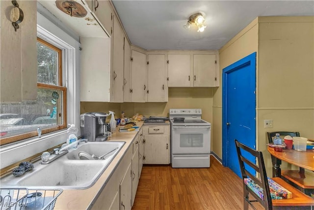 81 S Pleasant St, Oberlin, OH 44074 - kitchen with white electric stove, light countertops, and light wood-style floors