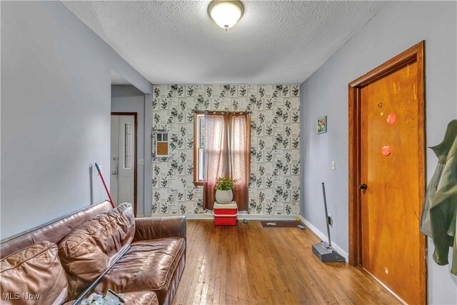 81 S Pleasant St, Oberlin, OH 44074 - sitting room with wallpapered walls, a textured ceiling, and wood-type flooring