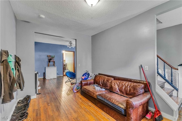81 S Pleasant St, Oberlin, OH 44074 - living area featuring hardwood / wood-style flooring, a textured ceiling, and stairway