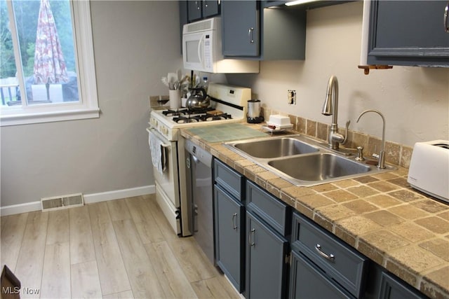 2869 Wexford Blvd, Stow, OH 44224 - kitchen with white appliances, light wood-type flooring, and tile counters