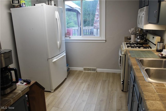 2869 Wexford Blvd, Stow, OH 44224 - kitchen with white appliances, tile countertops, and light wood-type flooring