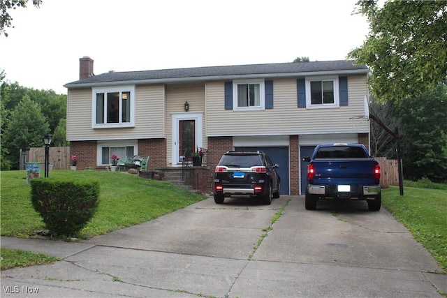 2869 Wexford Blvd, Stow, OH 44224 - split foyer home featuring brick siding, a chimney, driveway, an attached garage, and a front lawn